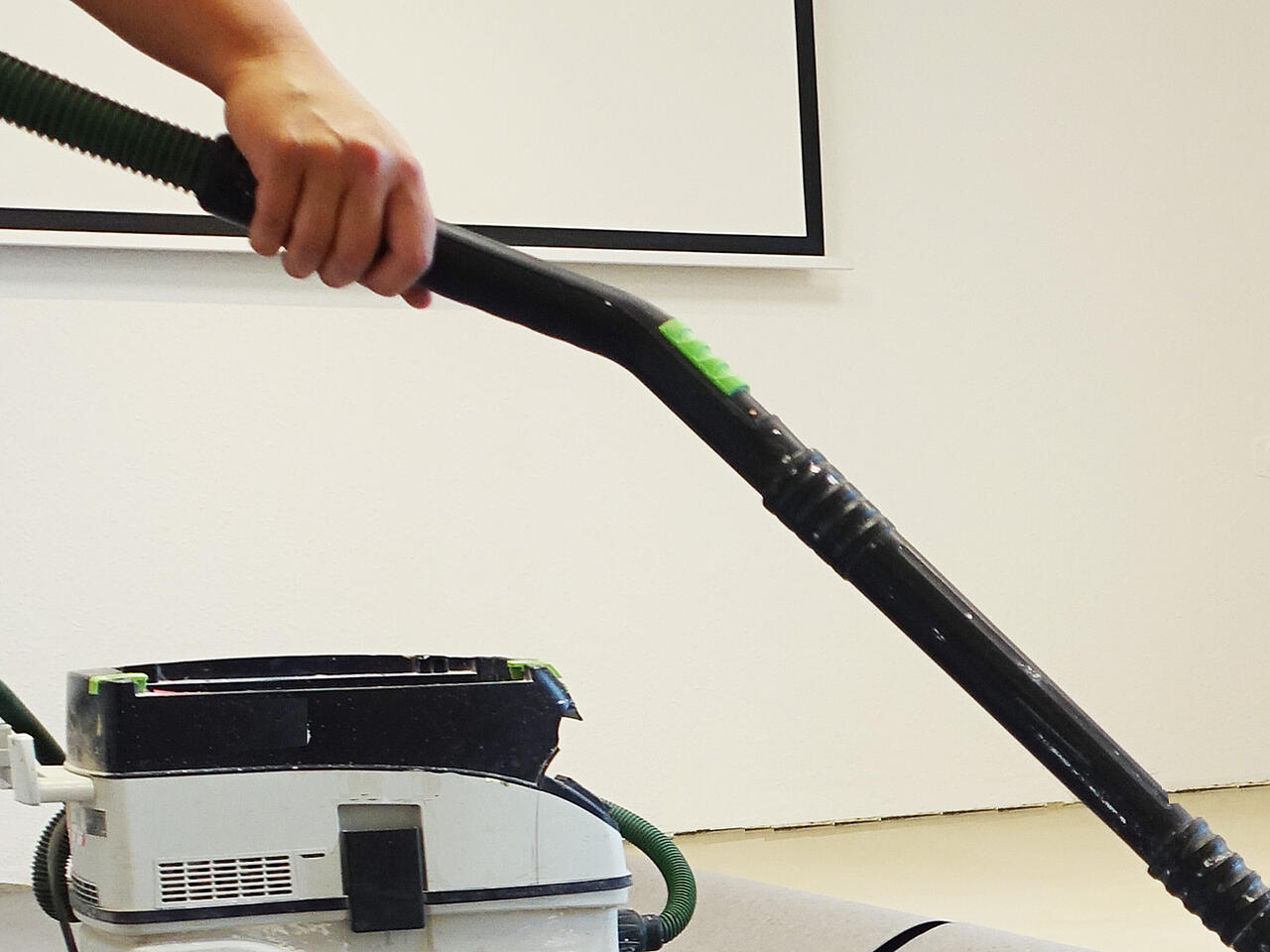 Outstretched arm with hoover pipe in training room